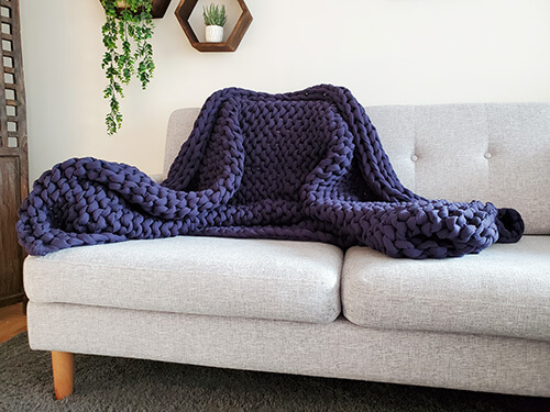 Bearaby Cotton Napper weighted blanket on a sofa