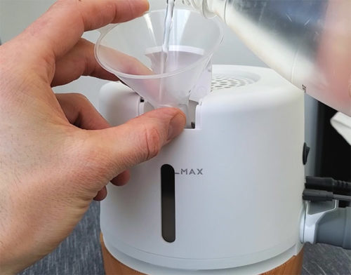 photo showing pouring water into the moona device when installing it